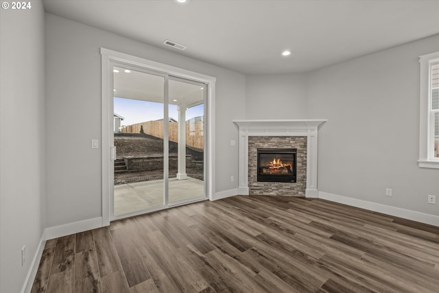 unfurnished living room featuring a fireplace and hardwood / wood-style floors