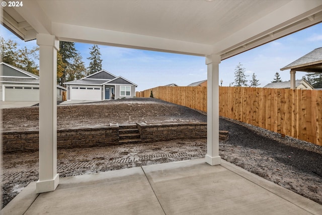 view of patio featuring a garage and an outdoor structure