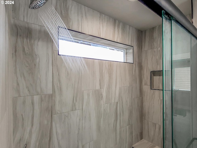 bathroom with a shower with shower door