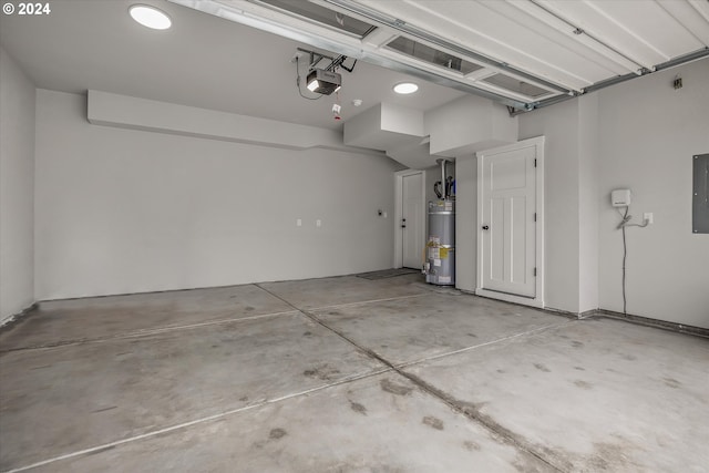 garage featuring electric panel, water heater, and a garage door opener