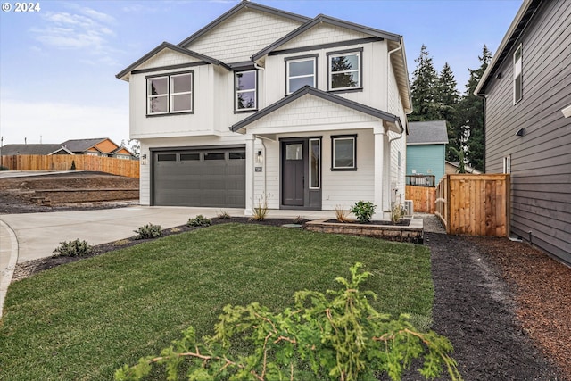 view of front of house with a garage and a front lawn