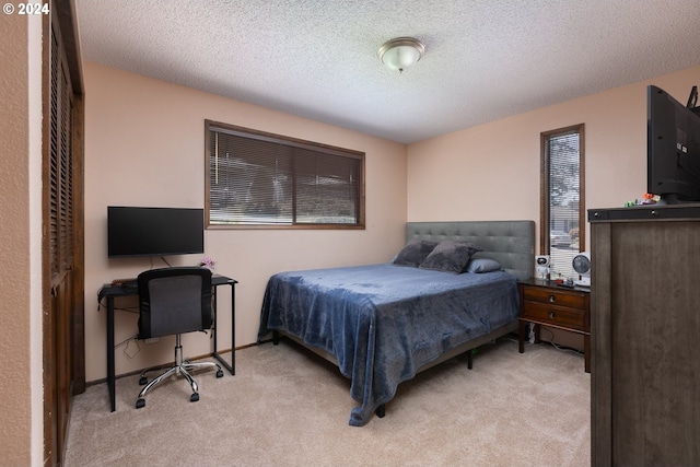 carpeted bedroom featuring a textured ceiling