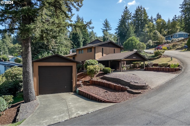 view of front of home with a garage and a carport