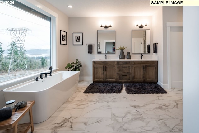 bathroom featuring vanity and a tub