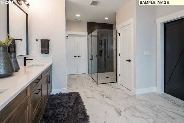 bathroom featuring vanity and an enclosed shower