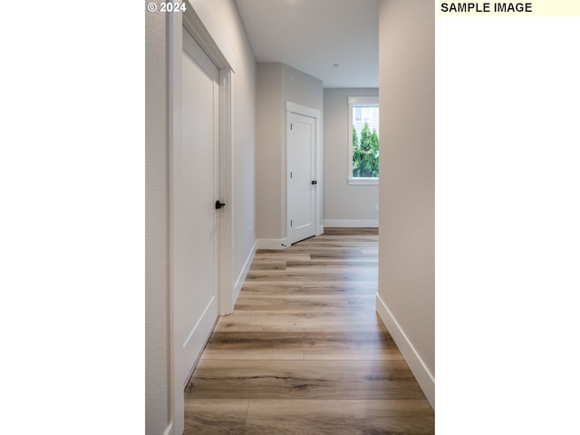 corridor with light wood-type flooring