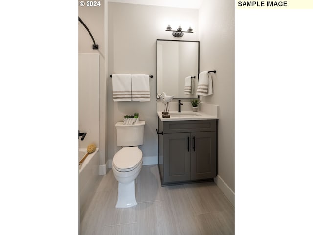 full bathroom featuring toilet, vanity, and tub / shower combination