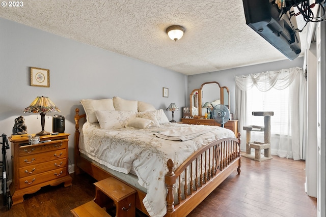 bedroom featuring a textured ceiling and wood-type flooring