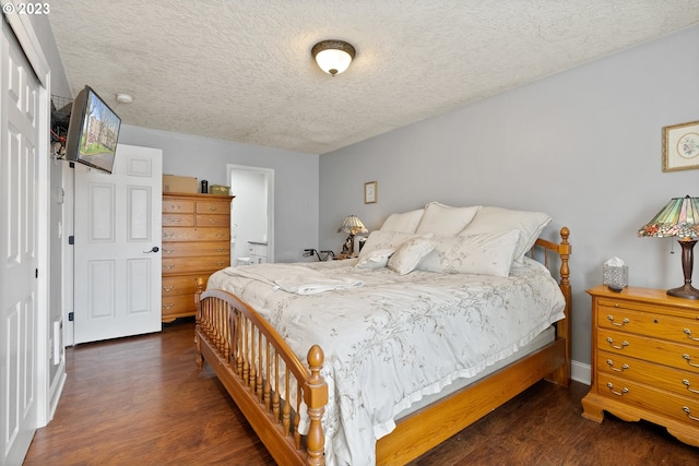 bedroom featuring a textured ceiling, a closet, and dark hardwood / wood-style flooring