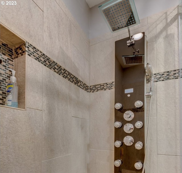 bathroom featuring tile walls and tiled shower