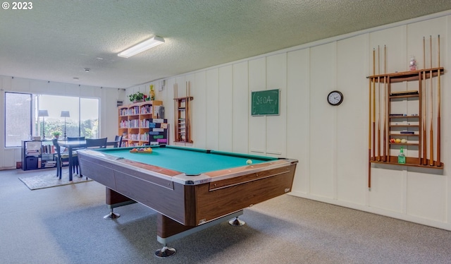 recreation room featuring a textured ceiling, pool table, and light colored carpet