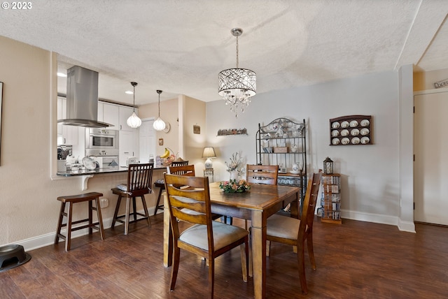 dining area with a textured ceiling, a chandelier, and dark hardwood / wood-style floors