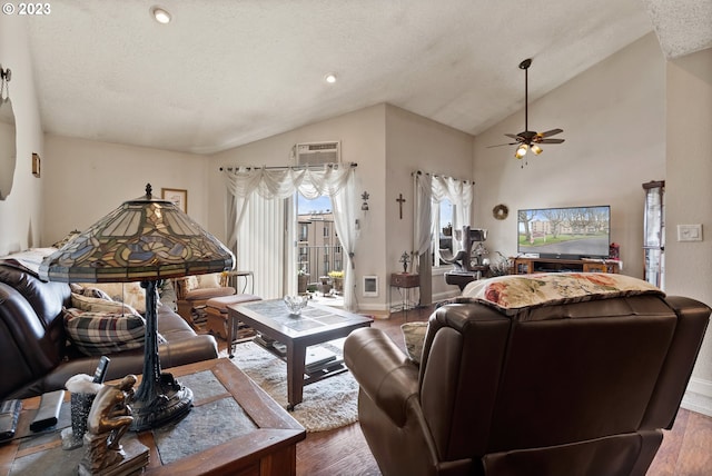 living room featuring a textured ceiling, wood-type flooring, and ceiling fan