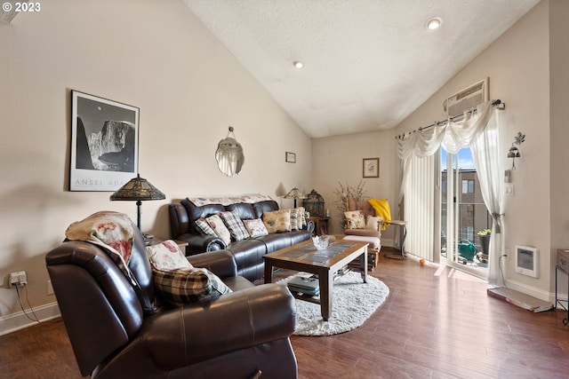 living room with dark wood-type flooring, high vaulted ceiling, a textured ceiling, and heating unit