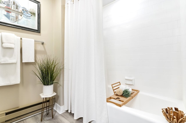 bathroom featuring hardwood / wood-style flooring, shower / bath combo with shower curtain, and a baseboard radiator