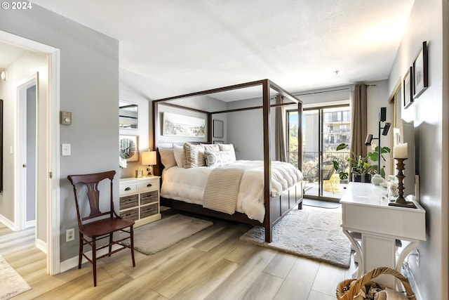 bedroom featuring light hardwood / wood-style flooring and access to exterior