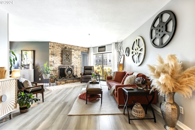 living room with a fireplace and light wood-type flooring