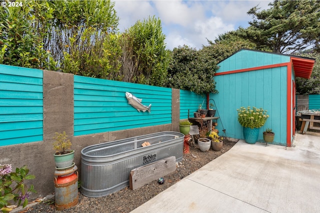 view of patio featuring a shed