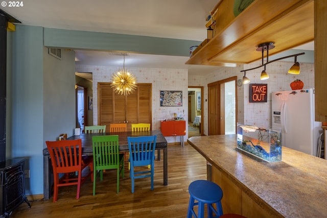 dining room with a notable chandelier and hardwood / wood-style floors