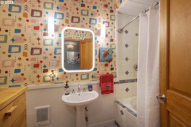 bathroom with shower / tub combo and sink