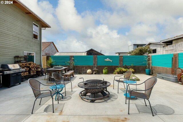 view of patio / terrace featuring an outdoor fire pit and a grill