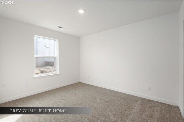 carpeted empty room with recessed lighting, visible vents, and baseboards