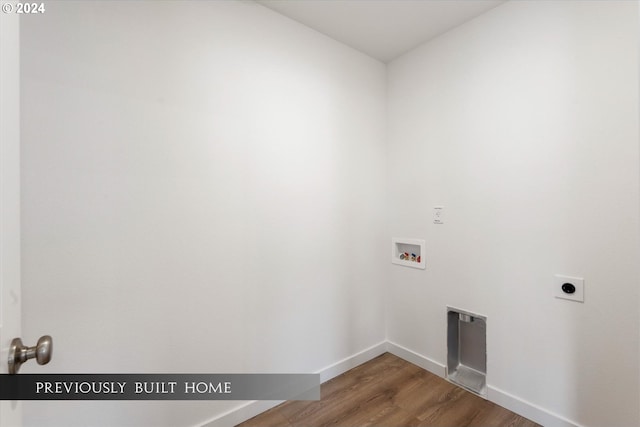 washroom featuring washer hookup, electric dryer hookup, wood finished floors, laundry area, and baseboards