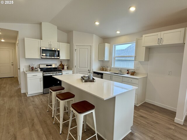 interior space with a notable chandelier, recessed lighting, vaulted ceiling, wood finished floors, and baseboards