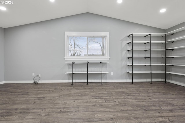 interior space with dark wood-type flooring and vaulted ceiling