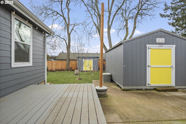 deck featuring a shed and a lawn