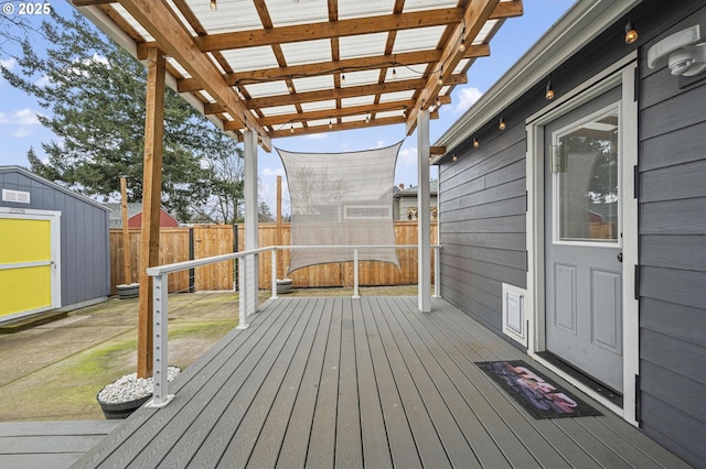 deck featuring a pergola and a shed