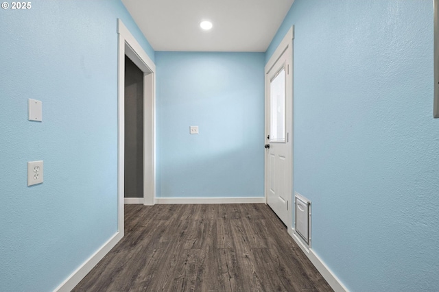 hallway with dark wood-type flooring