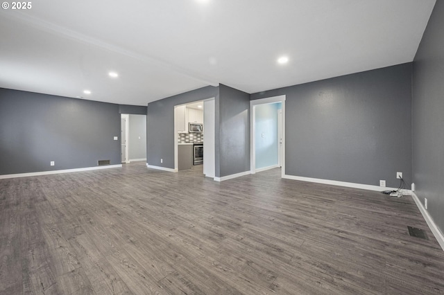 unfurnished living room with dark hardwood / wood-style floors