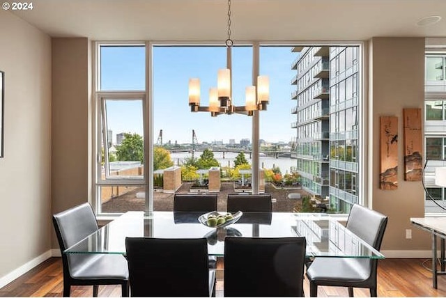 dining area featuring a chandelier, hardwood / wood-style flooring, and a wealth of natural light