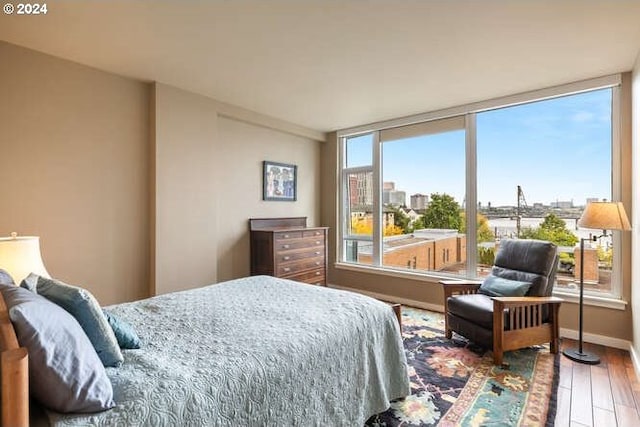 bedroom with hardwood / wood-style flooring and multiple windows