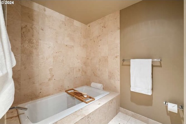 bathroom with tile patterned flooring and a relaxing tiled tub