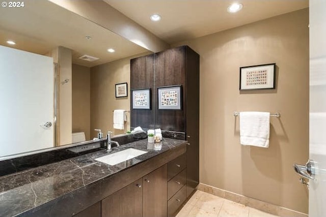 bathroom with tile patterned floors, vanity, and toilet