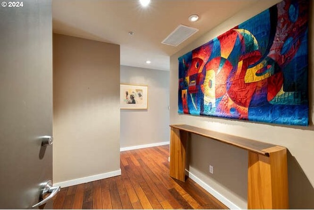 corridor with visible vents, recessed lighting, baseboards, and wood-type flooring