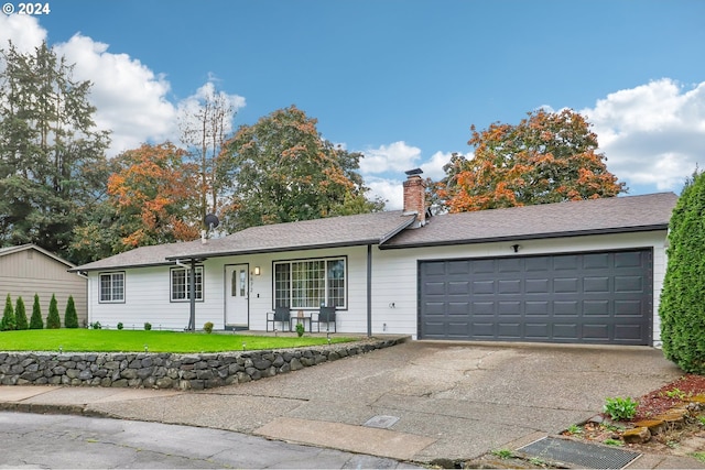 ranch-style house with a garage and a front lawn