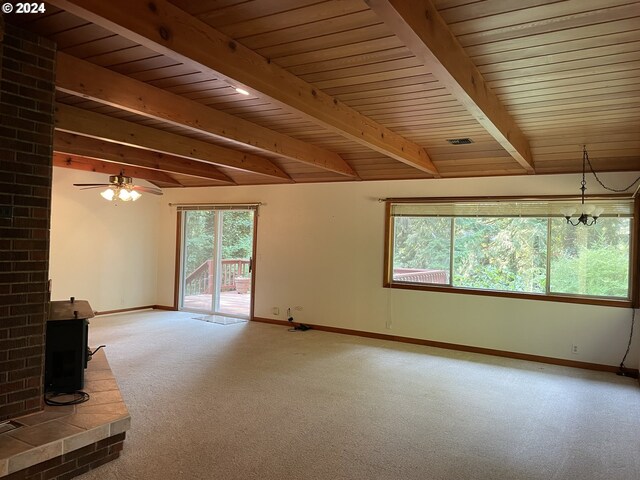 87535 Tiernan Rd, Mapleton, OR 97453 - unfurnished living room with beamed ceiling, carpet, baseboards, a wood stove, and wood ceiling