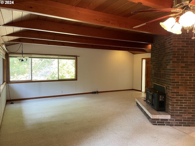 87535 Tiernan Rd, Mapleton, OR 97453 - unfurnished living room featuring carpet flooring, lofted ceiling with beams, a wood stove, baseboards, and ceiling fan