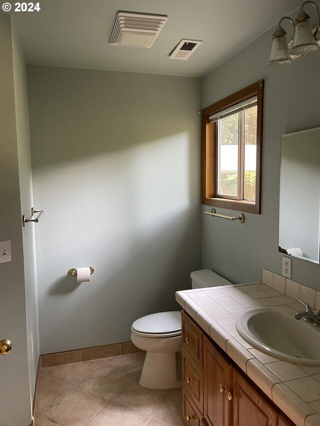 87535 Tiernan Rd, Mapleton, OR 97453 - half bathroom with visible vents, toilet, tile patterned floors, and vanity