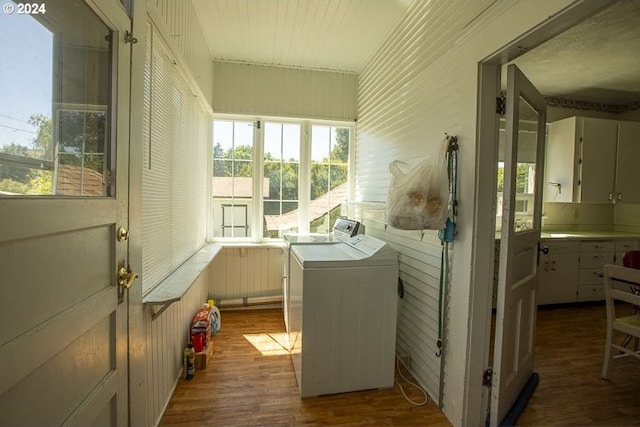 laundry area featuring wood walls, hardwood / wood-style flooring, and independent washer and dryer