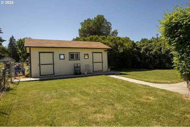 view of outbuilding featuring a yard