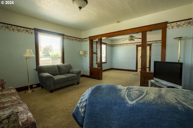 living room featuring ceiling fan and carpet