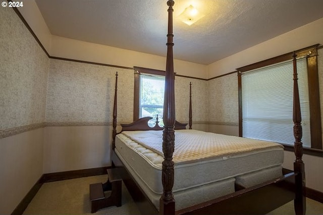 carpeted bedroom featuring a textured ceiling