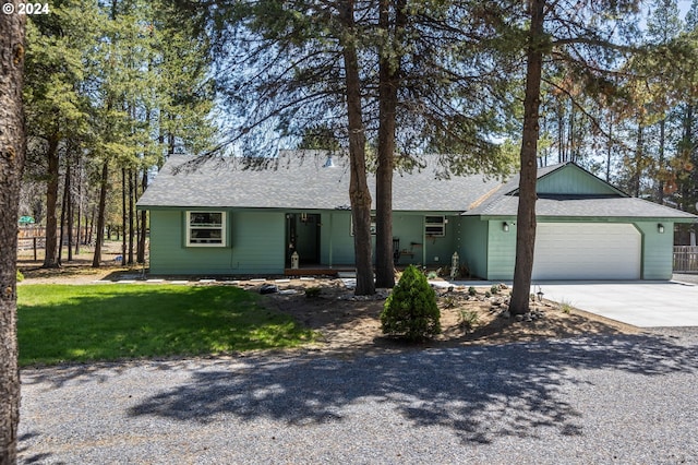 ranch-style home with a garage and a front lawn