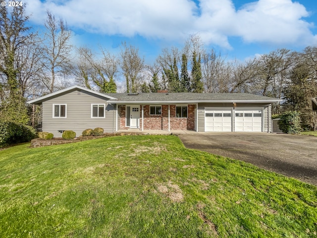 ranch-style home with a front yard and a garage