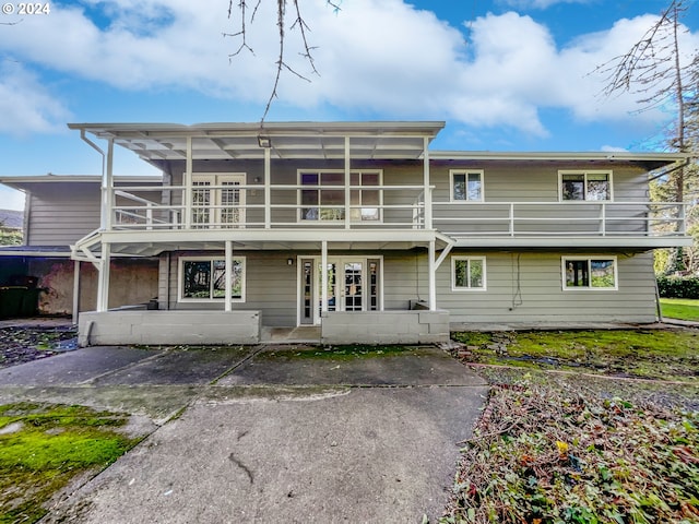 back of house featuring a patio area and a balcony