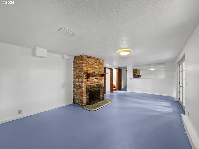 unfurnished living room with a textured ceiling and a fireplace